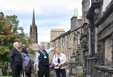 tour guide showing visitors around the kirk