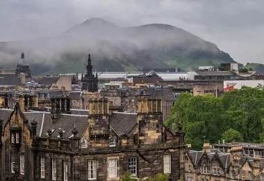 view of the old town in edinburgh, covered in fog and haze