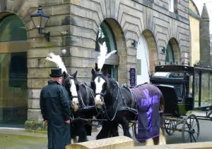 view of a horse-drawn hearse outside of Greyfriars Kirk
